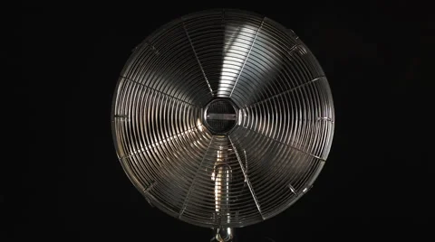 Fan with grid, on black background, yellow light Stock Footage 52932172