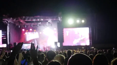 Fan person records video and takes pictures on smart phone at concert party Stock Footage