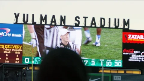 Fan Standing In front of college football jumbotron stadium Stock Footage