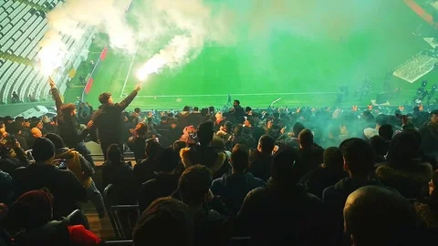 Fanatical fans lighting torches inside the stadium Stock Footage