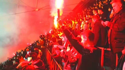 Fanatical fans lighting torches inside the stadium Stock Footage
