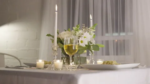 A Fancy Candlelit Dinner Table with a Glass of White Wine Stock Footage 208722151