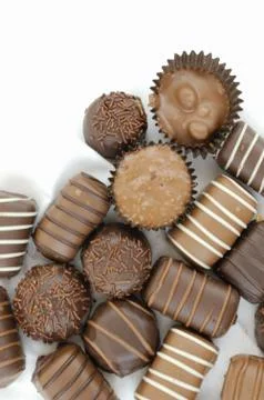 Fancy chocolates in wrappers on white Stock Photos
