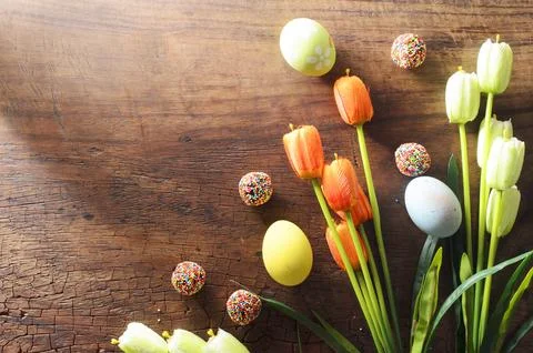 Fancy Easter eggs and tulips flower decoration on wooden backgrounds with c.. Stock Photos