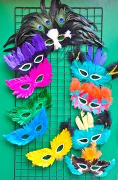 Fancy masks on the green wall Stock Photos