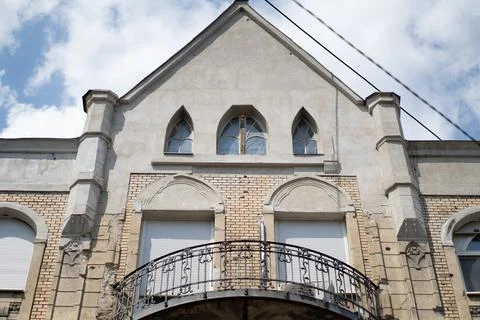 Fancy old designed symmetrical building with an elegant balcony Stock Photos