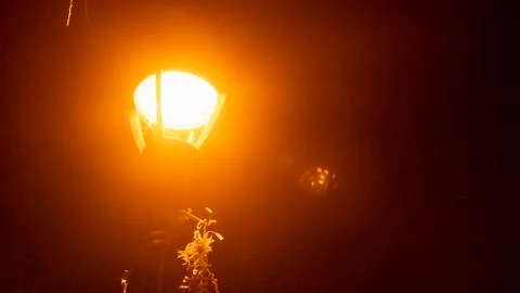 Fancy Old Light Pole Beaming Orange Vapor Light Stock Photos