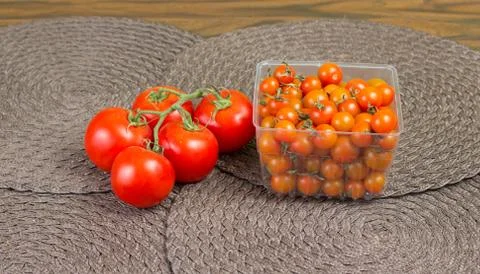 Fancy orange cherry tomatoes and red tomatoes on vine. Stock Photos