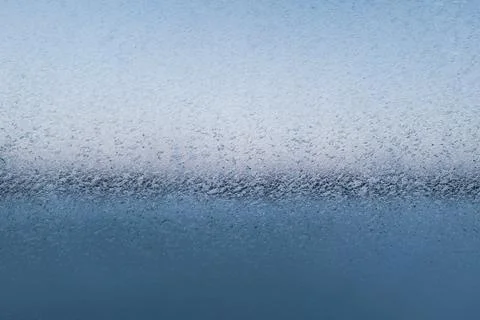 Fancy patterns drawn on a frosty winter day. Snow patterns on the glass Stock Photos