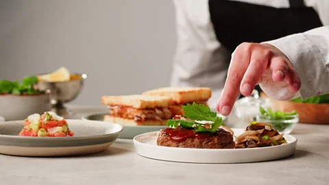 Fancy restaurant table, chef adding green parsley cilantro on top close-up Stock Footage 258379586