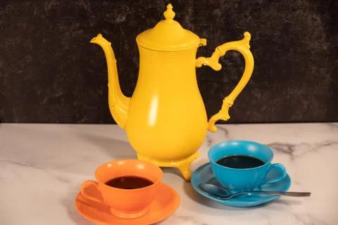 Fancy but simple tea set bright colored coffee cups filled with black tea Stock Photos