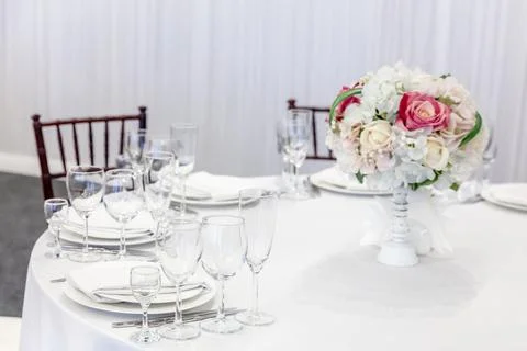 Fancy table set for dinner with flower composition in restaurant, luxury inte Stock Photos