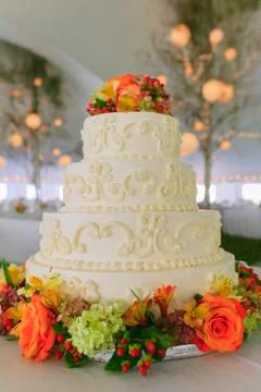 Fancy wedding cake inside a large event tent. Stock Photos