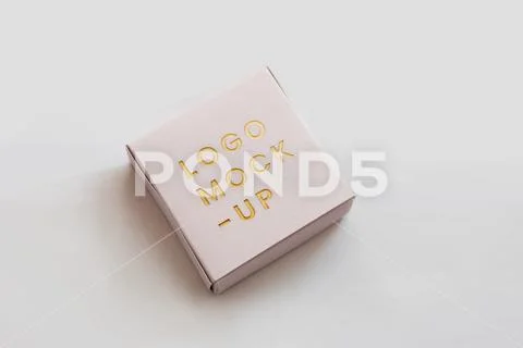 Fancy white box debossed gold glitter logo mockup PSD Template