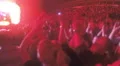 Fans applauding to popular band on brightly illuminated stage. Show on stadium HD Footage