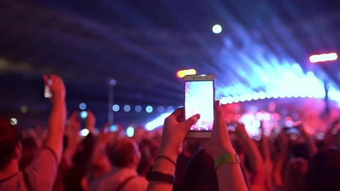 Fans are dancing and filming a video of the concert on smartphones. Stock Footage 225288300
