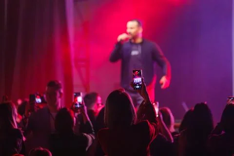 Fans capturing live concert performance on their mobile devices in a vibrant Stock Photos