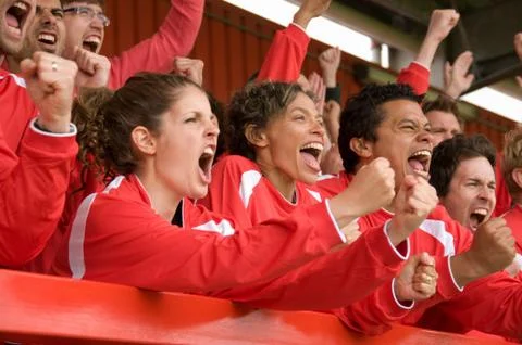 Fans celebrating at football match Stock Photos