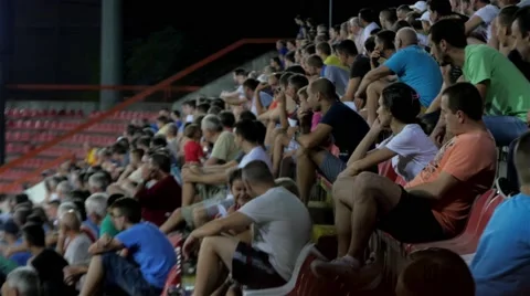 Fans crowd sitting on stadium seats, people watching soccer or football game, 4K Stock Footage 55745398