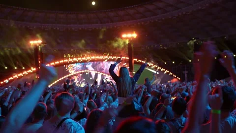 Fans dance and wave in front of the stage at a concert. Stock Footage 231510689