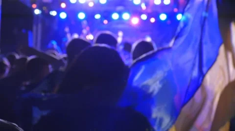 Fans dancing with Ukrainian flag on concert. Slow motion Stock Footage 65384430