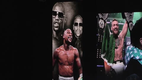 Fans flock to see Conor McGregor and Floyd Mayweather weigh in Stock Footage 148676354