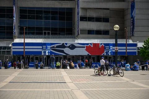 Fans gather outside the stadium before a baseball game. Stock Photos