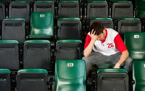 Fans: man sits alone after losing Stock Photos