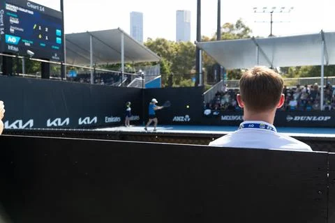 A fan's perspective watching a women's qualifying singles tennis match on C.. Stock Photos