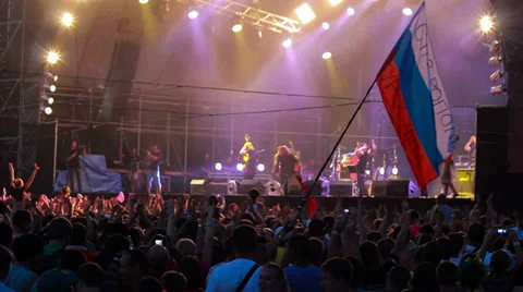 Fans with russian flag at live performance of rock band Bi-2. Defocus. Stock Footage 31815064