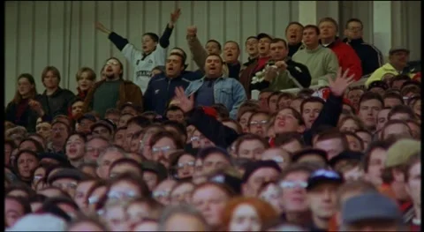 Fans sitting at stadium, watching match and cheering, UK 90s Stock Footage 159443514