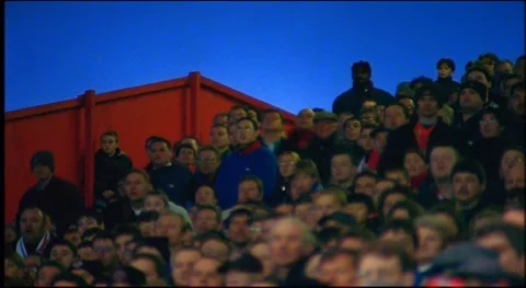 Fans at stadium standing up to cheer and applause while watching football match Vidéo 159443616