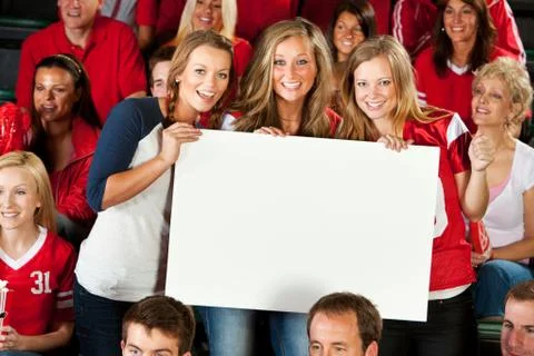 Fans: three girlfriends hold up blank sign Stock Photos