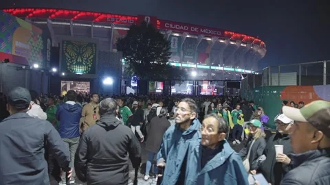 Fans walk past Estadio Azteca at night Stock Footage 345278493