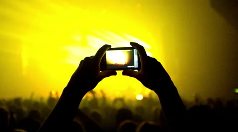 Fans waving their hands and hold the phone with digital displays Stock Footage 55787967