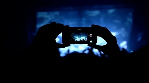 Fans waving their hands and hold the phone with digital displays Stock Footage 61727414
