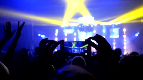 Fans waving their hands and hold the phone with digital displays Stock Footage 61727502