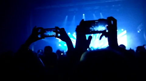 Fans waving their hands and hold the phone with digital displays Stock Footage 61727558