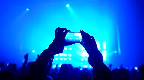 Fans waving their hands and hold the phone with digital displays Stock Footage 61727665