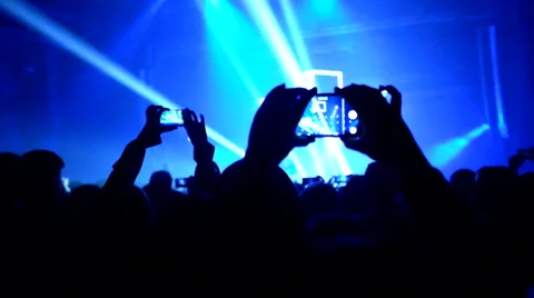 Fans waving their hands and hold the phone with digital displays Stock Footage 61727678