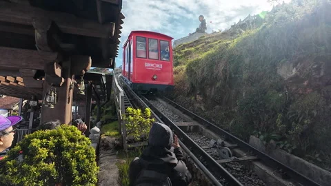 Fansipan funicular mountain train coming down and entering station Stock Footage 295166355