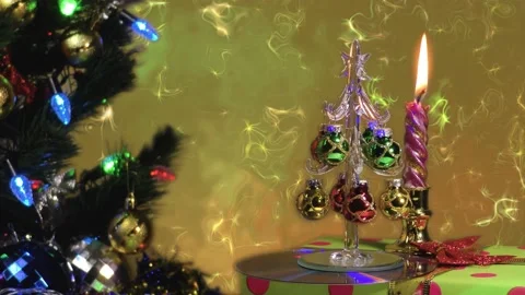 Fantastic background. Large green tree with lights. Burning candle. 動画素材 145408516