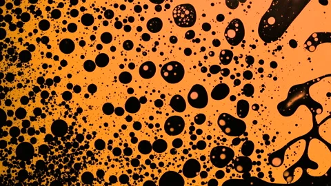 Fantastic black bubbles in orange ink. Scientific experiment, chemical reactions Stock Footage 149287066