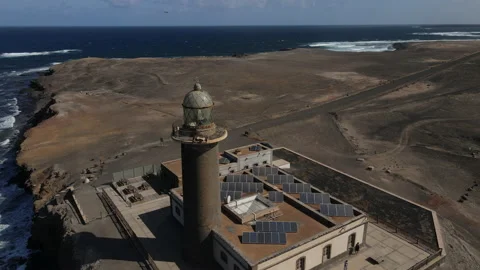 Fantastic circular aerial shot at a short distance over the lighthouse of Stock Footage 208028448