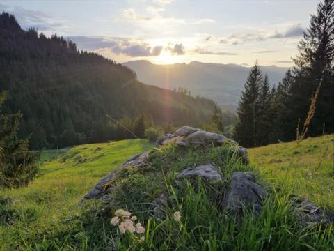 Fantastic colorful sunset with rocks and grass in foreground. Allgaeu, Bavaria Stock Photos