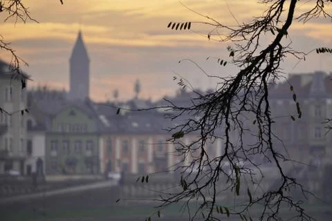 Fantastic Dramatic Bright sunset over the old town through the branches of tr Foto stock
