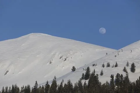 Fantastic evening winter landscape. Dramatic sky with fool moon Stock Photos