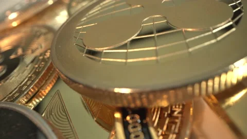 Fantastic MACRO shot of gold crypto coins rotate on the table from Laowa 24 mm Stock Footage 132321724