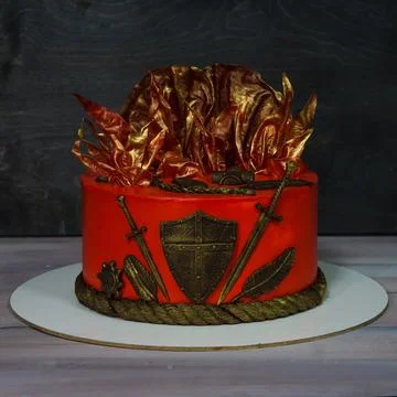 Fantastic red game of thrones cake with gilded decoration Stock Photos