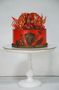 Fantastic red game of thrones cake with gilded decoration Stock Photos